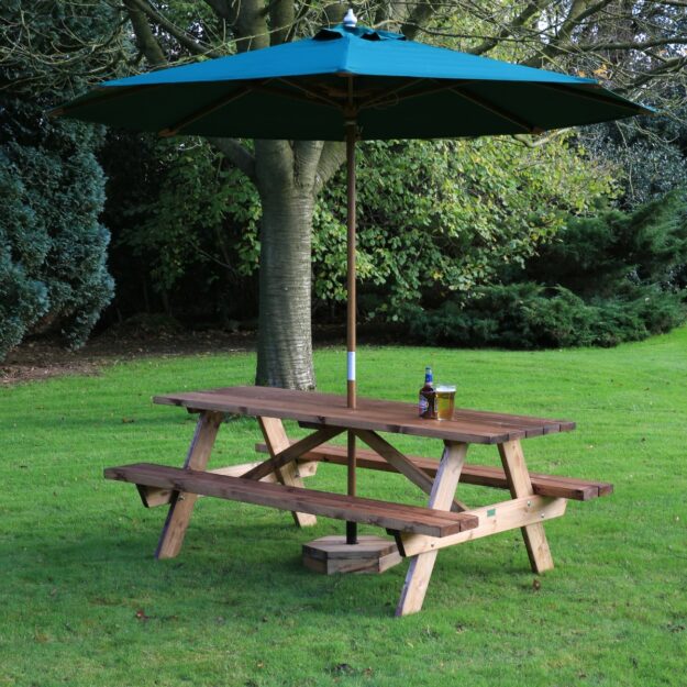 A 2m long wooden A frame picnic table located on a lawn with a green parasol