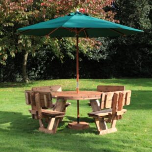A circular wooden picnic table with 8 seats with back rests on a lawn