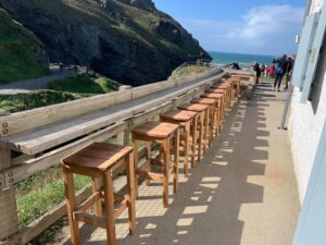 Solidly built wooden bar stools located at the outdoor cafe, Tintagel Castle