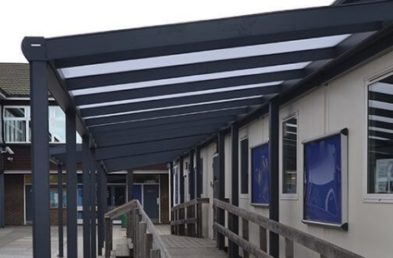 A metal framed covered walkway at a school
