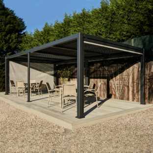 A dark grey metal gazebo with a flat slatted roof on a garden deck with rattan dining furniture underneath