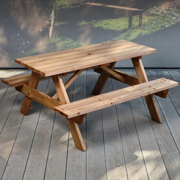 A heavy duty commercial 6 seater wooden picnic table situated at an angle on a grey outdoor deck