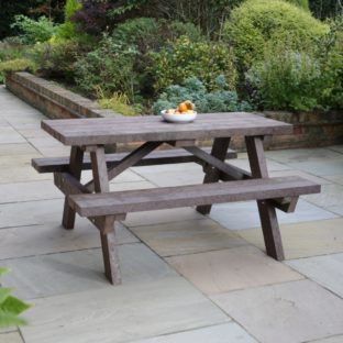 A brown recycled plastic picnic table on a patio