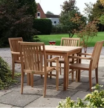 Teak 4 seater square table and 4 armchairs in a pub garden